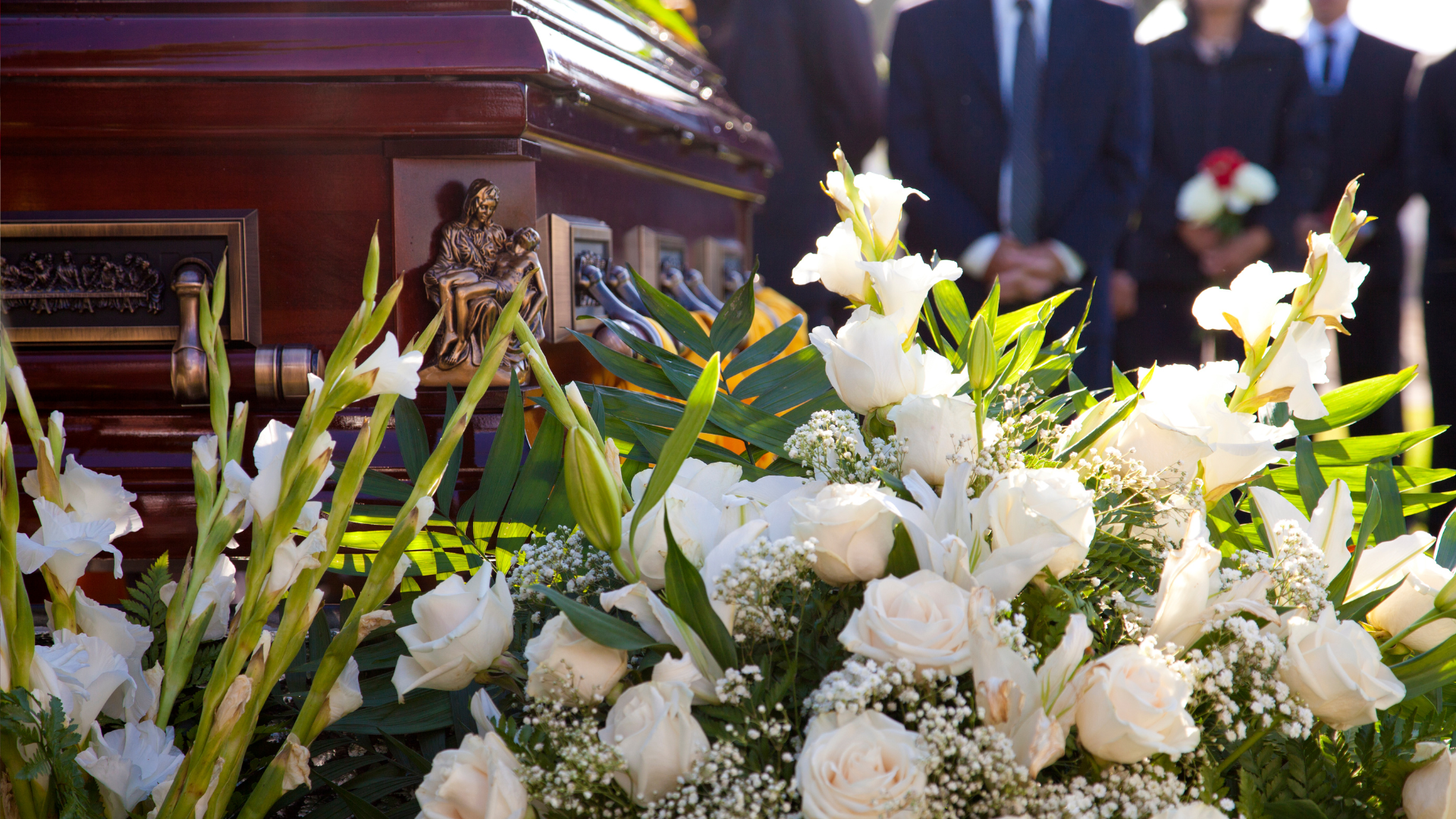 bestattung-in-karlsruhe Ein mit Blumen geschmückter Sarg bei einer Beerdigung in Karlsruhe.